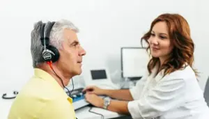 Audiologist performing a hearing test on a patient in a modern clinic.